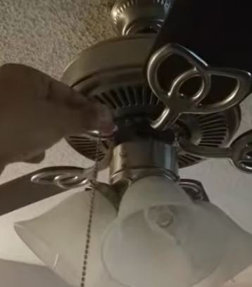 Electrician repairing a ceiling fan motor in a Broken Arrow, OK home
